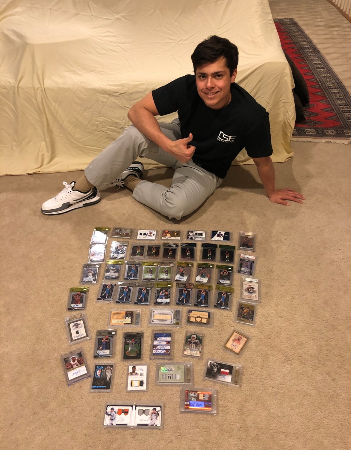 Zachary Lynch poses with a portion of his own collection of collectible sports cards. Lynch is a finance student at Texas A&M and has worked with two partners to form Card Stock Exchange, a website that tracks trading card value with a mindset that each card is a financial investment – not just a collectible.